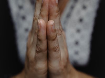 A person's hands in a meditative mudra position.